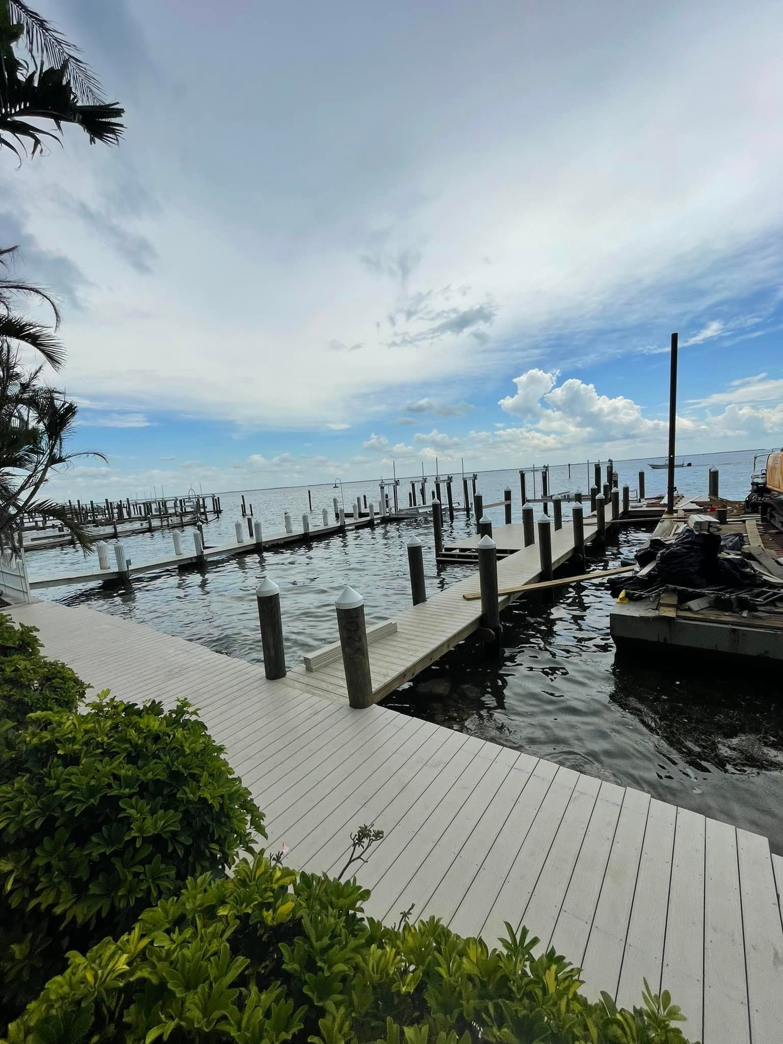 Composite walkways and boat slips during repair work at a waterfront marina. Dock and pier maintenance, Anderson Dock and Lift, Sarasota County FL.