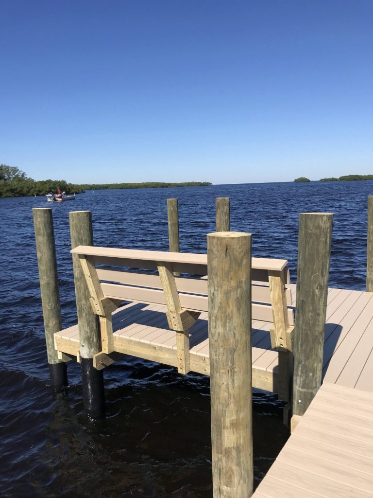 Dock with built in bench seating over open water near mangroves. Custom dock construction by Anderson Dock and Lift, St. Petersburg FL.