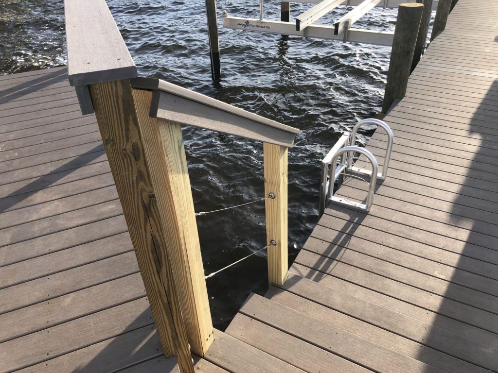 Dock with cable railing, gate opening and an aluminum swim ladder. Custom dock construction by Anderson Dock and Lift, Sarasota FL.