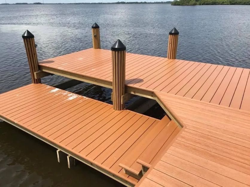 Two level composite dock with a lower platform and capped pilings. Custom dock builder Anderson Dock and Lift, St. Petersburg FL.