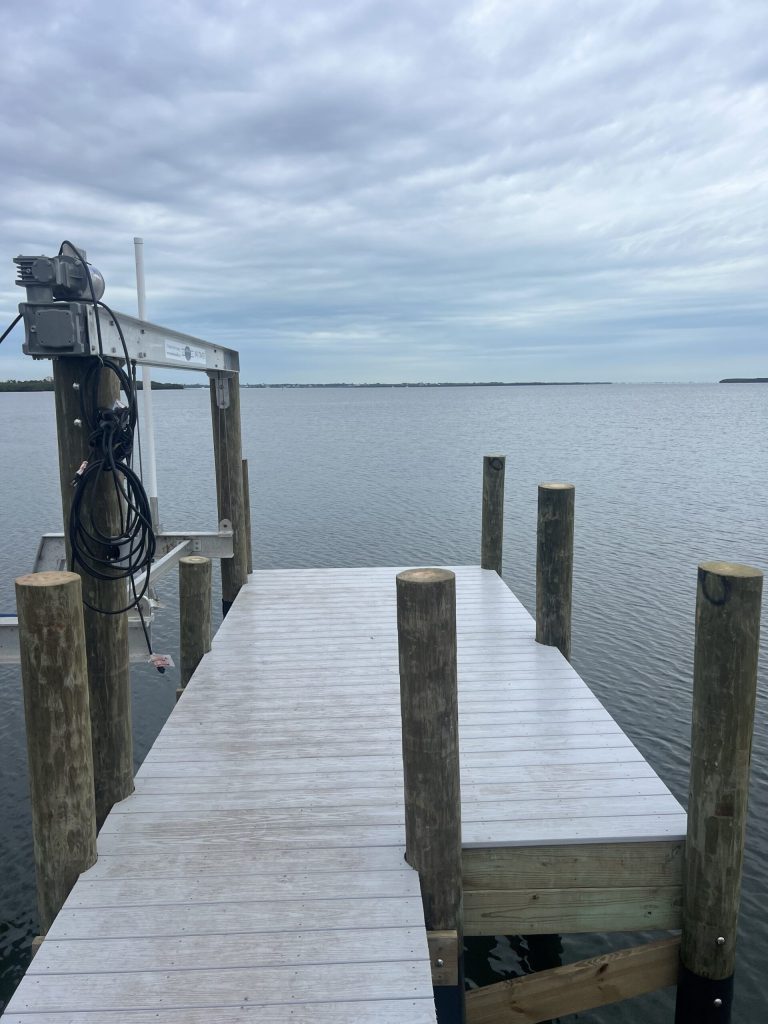 Dock T head with a boat lift and its electrical control panel. Boat lift installation by Anderson Dock and Lift, Fort Myers FL.