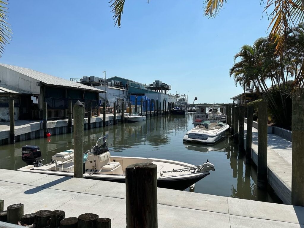 Boats moored along commercial seawall and docks at the Swordfish Grill working waterfront in Cortez. Commercial marine construction, Anderson Dock and Lift, Cortez FL.