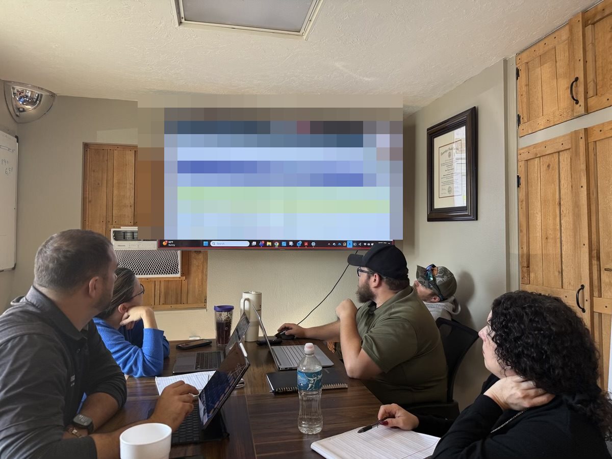 The Anderson Dock and Lift office team reviewing the job schedule at the Bradenton office
